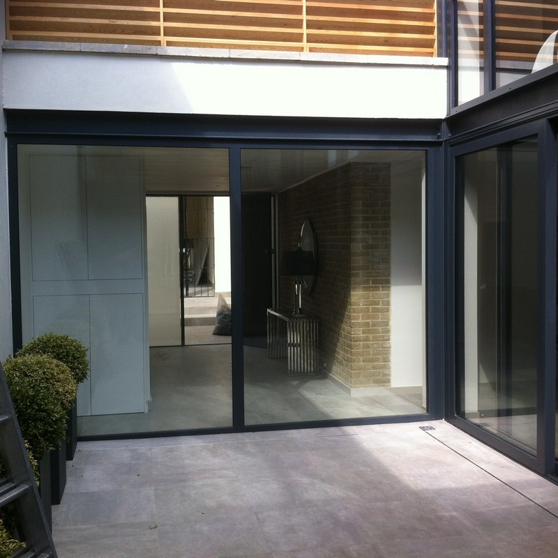 Floor-to-ceiling sliding doors opening to courtyard in Mayfair