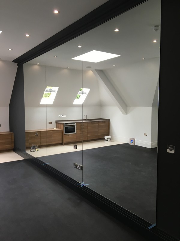 Frameless glass partition in loft conversion by Mayfair glaziers