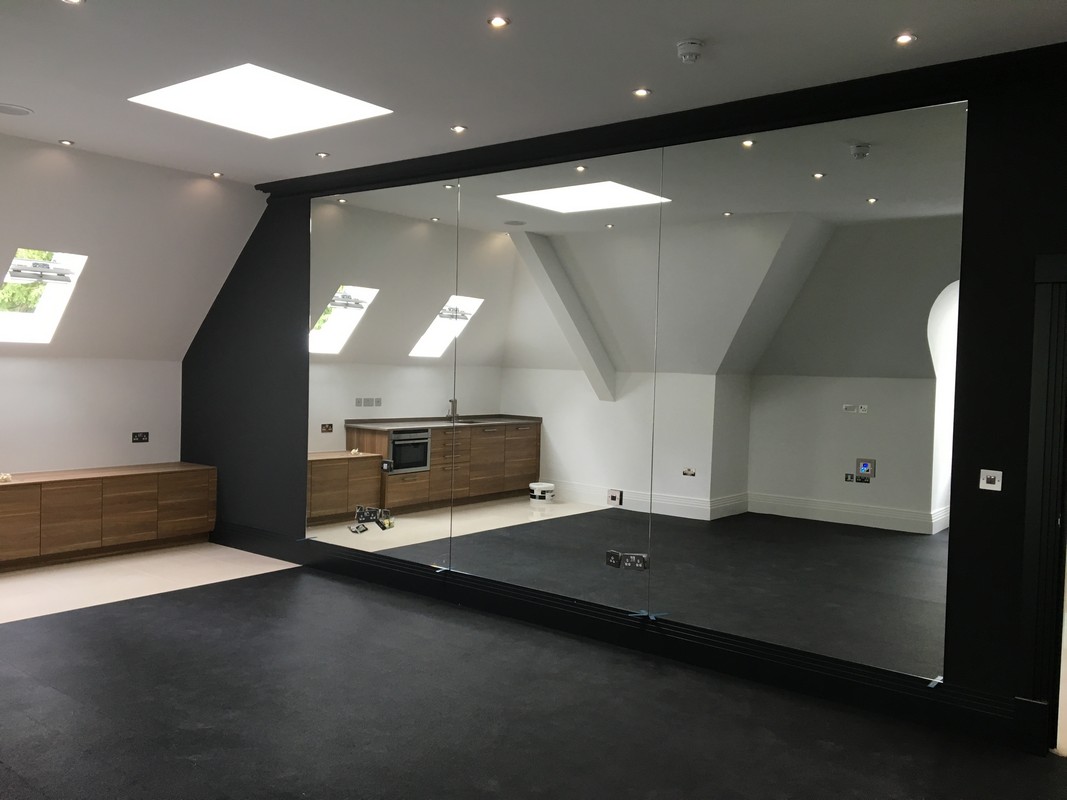 Frameless glass wall dividing loft conversion in Mayfair