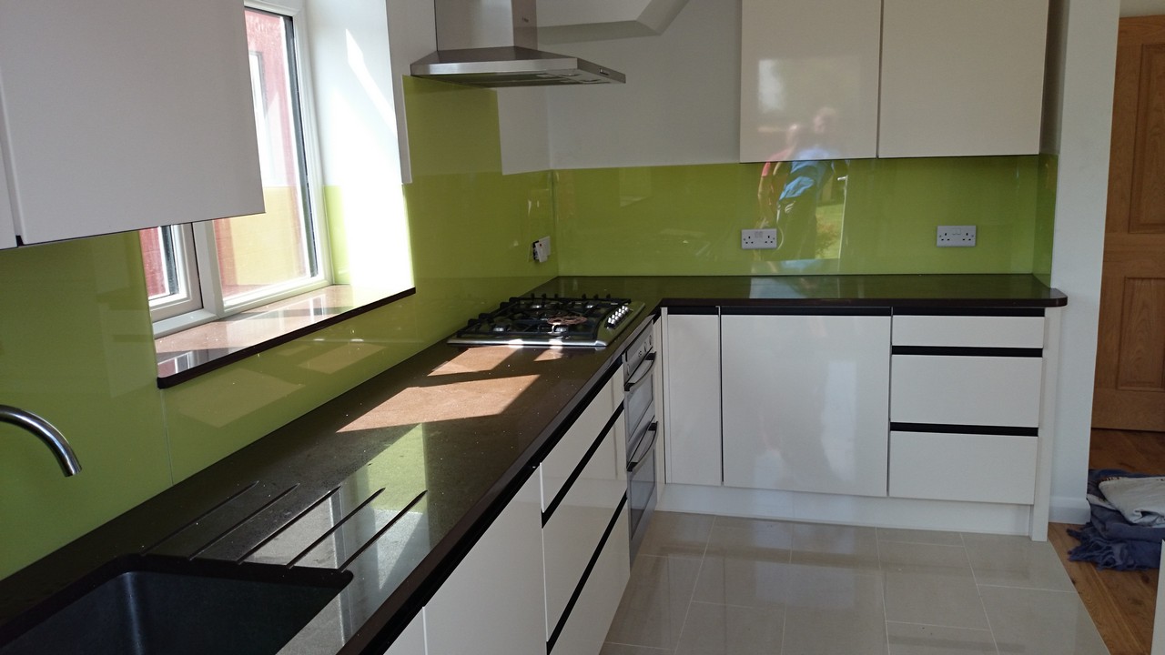 Lime green glass kitchen splashback installed by Mayfair glaziers